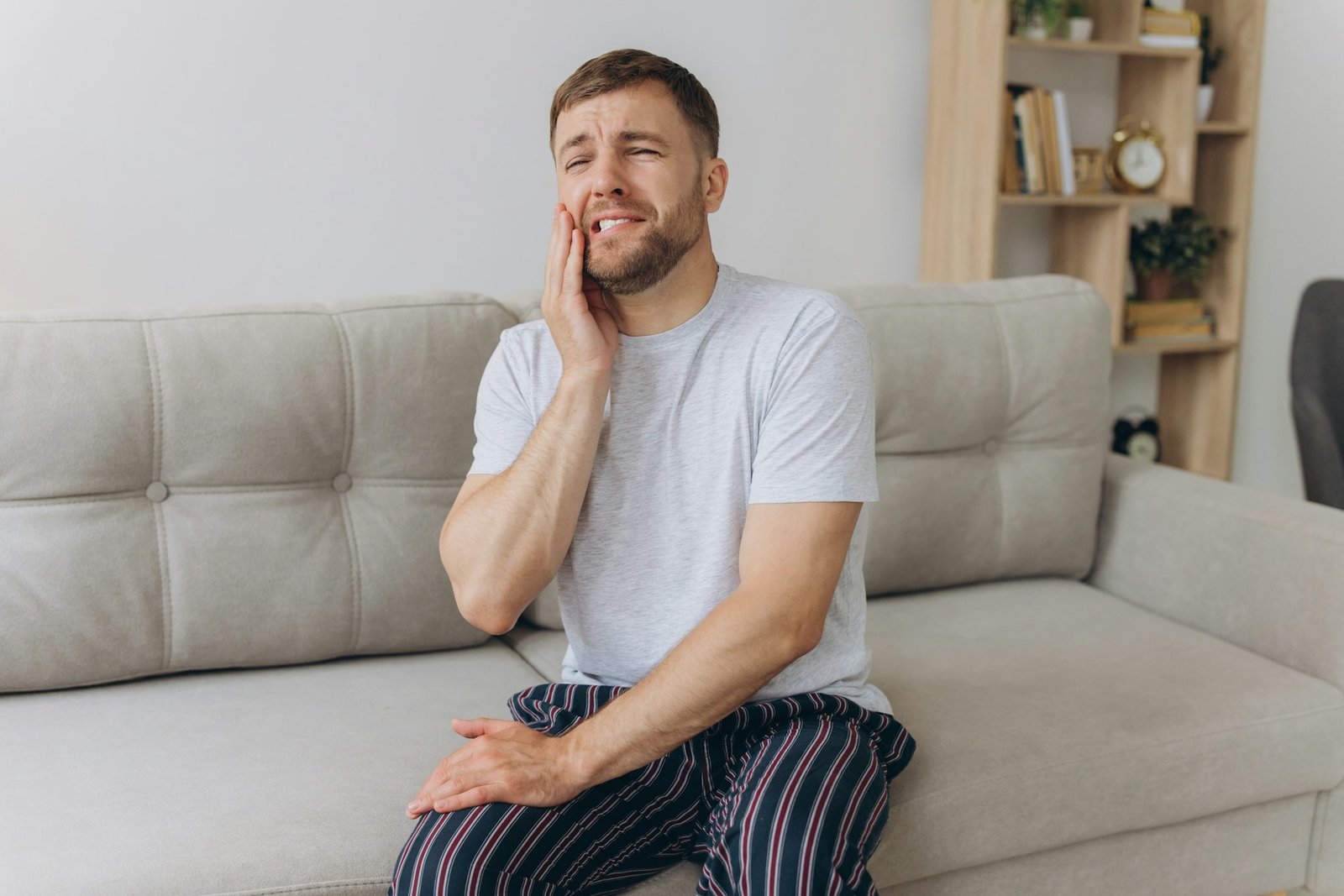 Dental health problems concept. Man suffering from strong toothache.