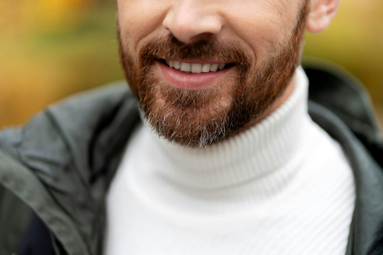 Smiling man with white teeth, outdoors