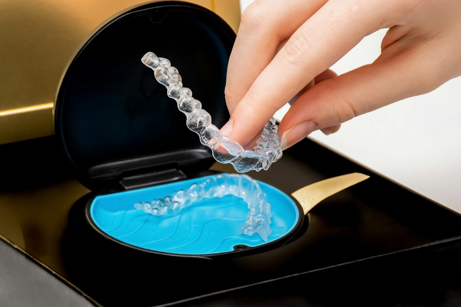 Transparent aligners in a box. Invisible braces. Clear teeth straighteners.