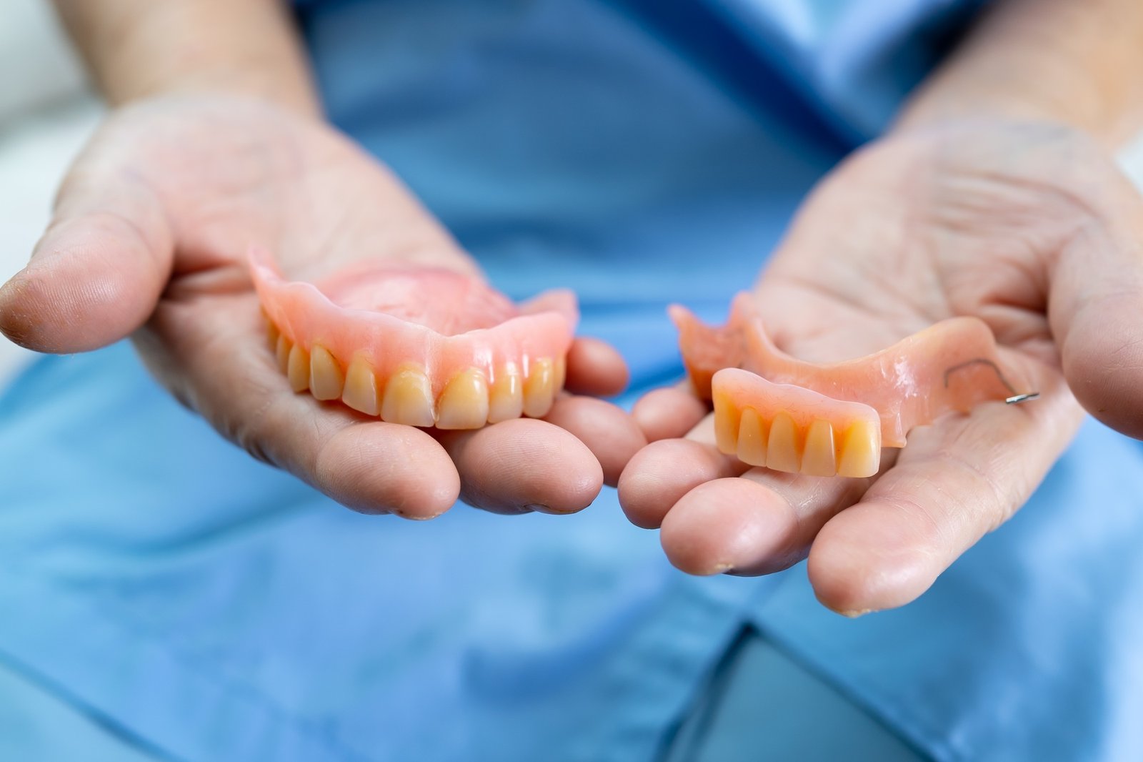 Asian senior woman patient holding to use denture in nursing hospital